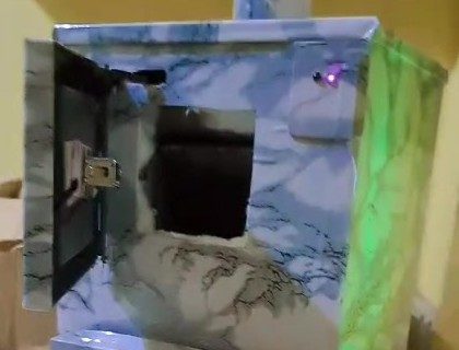 Techlance incinerator with the front-loading door open, showing the chute into the burning chamber